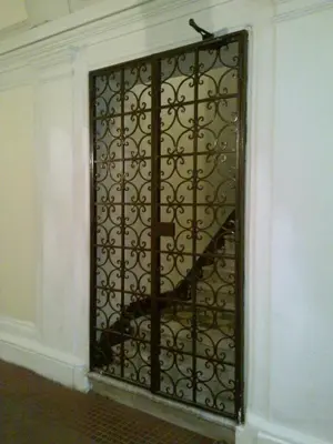 a iron gate with a staircase in a room at Hotel Lazzari in Rome