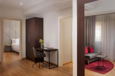 a room with a bed and a desk with a chair at NH Collection Roma Giustiniano in Rome