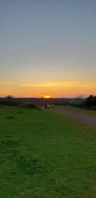 a field with the sun setting in the background at B&B J&B in Rome