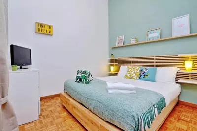 a bedroom with a bed and a tv on a wall at Parrotshouse in Rome