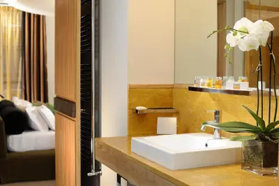 a bathroom with a white sink and a mirror at Babuino 181 - Small Luxury Hotels of the World in Rome