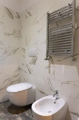 a white bathroom with a toilet and a sink at Vatican Plaza in Rome