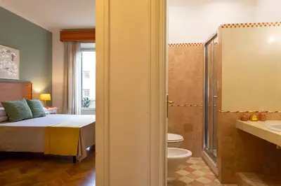 a bedroom with a bed and a bathroom with a shower at B&B A Casa di Tiziana - Roma in Rome