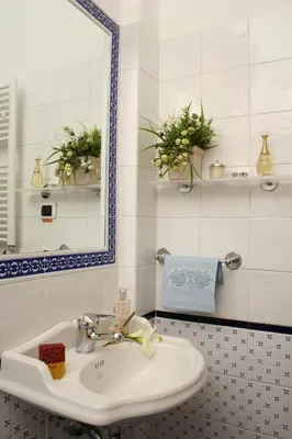 a bathroom with a sink and a mirror at B&B A Casa di Tiziana - Roma in Rome