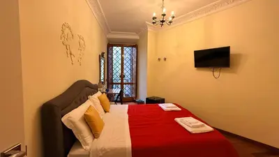 a bedroom with a bed with a red blanket at Vietitaly Filiberto in Rome