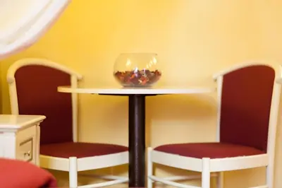 a table with two chairs and a bowl of fish at Sweet Dream Trevi in Rome
