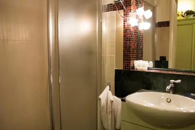 a bathroom with a sink and a shower at Sweet Dream Trevi in Rome
