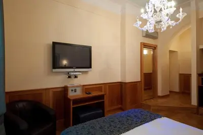 a room with a flat screen tv on the wall at Relais Conte Di Cavour De Luxe in Rome