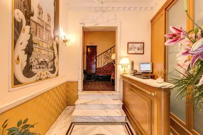 a hotel lobby with a reception desk and a hallway at Hotel La Lumiere Di Piazza Di Spagna in Rome