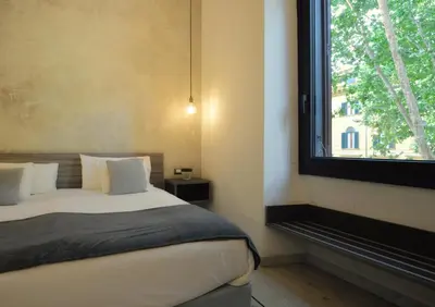 a bedroom with a bed and a window at Room with a view 105 in Rome