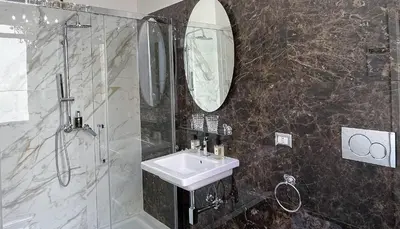 a bathroom with a sink and a shower and a mirror at Bed And Breakfast King Plaza in Rome