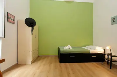 a bedroom with a bed and a green wall at Lucky Home rooms in Rome