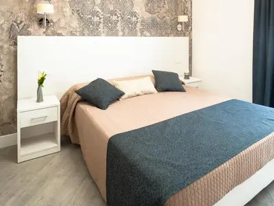 a bedroom with a large bed with blue pillows at Velvet Suite in Rome
