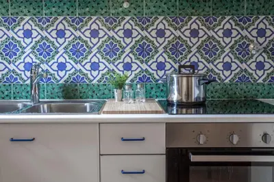 a kitchen with a sink and a tile wall at Domus Colosseum in Rome