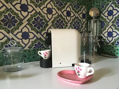 a kitchen counter with a toaster and two cups at Domus Colosseum in Rome
