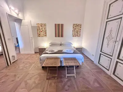 a bedroom with a large bed with pillows on it at Vicolo Doria Apartment in Rome