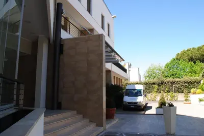 a white van parked next to a building at Ginevra Palace Hotel in Rome