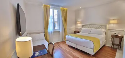 a hotel room with a bed and a window at Hotel Degli Artisti in Rome