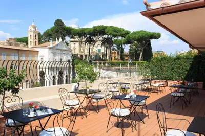 a group of tables and chairs on a patio at Hotel Degli Artisti in Rome