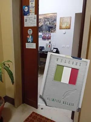 a sign with the flag of indonesia next to a desk at Olimpica Relais guest house in Rome