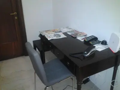 a desk with a chair and a phone on it at Olimpica Relais guest house in Rome