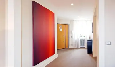 a hallway with a red wall in a room at Adamas Luxury Suite in Rome