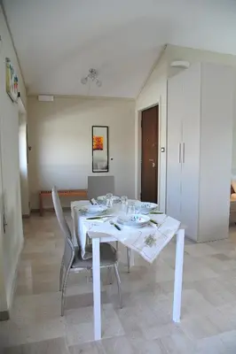 a white table and chairs in a room at Attico luminoso terrazza Metro A Aria Cond WiFi in Rome
