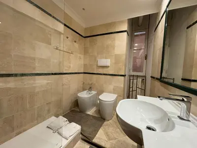 a bathroom with a sink and a toilet at Holidays Banchi Nuovi in Rome