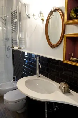 a bathroom with a sink and a toilet and a mirror at La Rosa del Vaticano Luxury Apartment in Rome