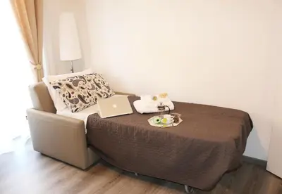a bed with a laptop and a plate of food on it at Le Fontane di Roma in Rome