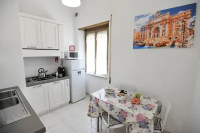a kitchen with a table with a table cloth on it at Le Fontane di Roma in Rome