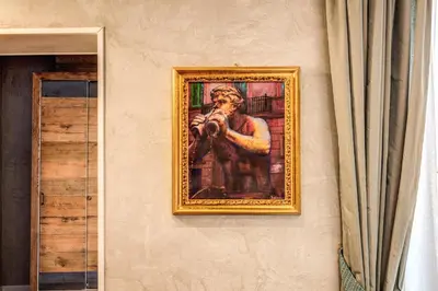 a painting of a man taking a picture on a wall at Parlamento Boutique Hotel in Rome