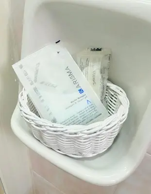 a white basket sitting on top of a refrigerator at Vertex Suite in Rome