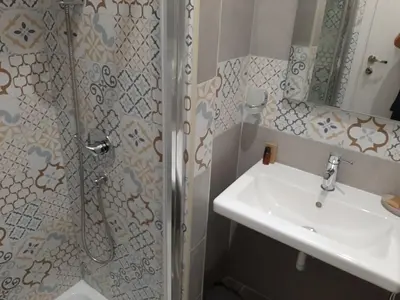 a bathroom with a sink and a shower at Roman Residence in Rome