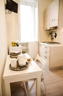 a kitchen with a table with dishes on it at Madonna dei Monti in Rome