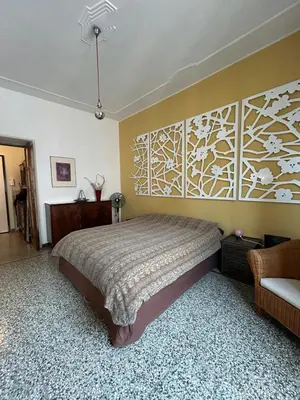 a bedroom with a bed and a wall with a flower mural at Our Home in Rome - Via Machiavelli in Rome