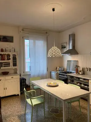 a kitchen with a table and chairs in it at Our Home in Rome - Via Machiavelli in Rome