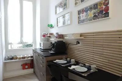 a small room with two beds and a table at B&B Roma Olimpic in Rome