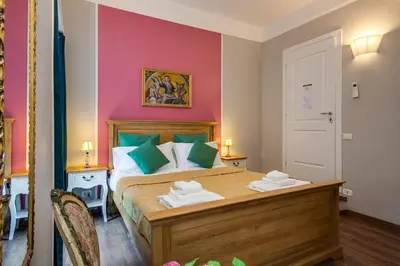 a bedroom with a bed with green and pink walls at Raphael Rooms in Rome