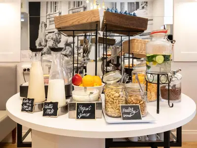 a table filled with food on a table with a counter at B&B Hotel Roma Italia Viminale in Rome