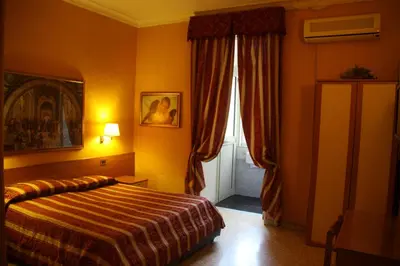 a hotel room with a bed and a window at Hotel Milazzo Roma in Rome