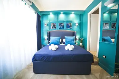 a blue bedroom with two teddy bears on a bed at Vatican Luxury Home in Rome