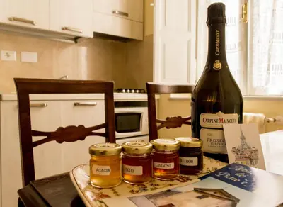 a bottle of wine sitting on a table with jam jars at Sant'Ivo Apartments in Rome