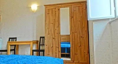 a wooden door leading to a bedroom with a table at Gite House in Rome