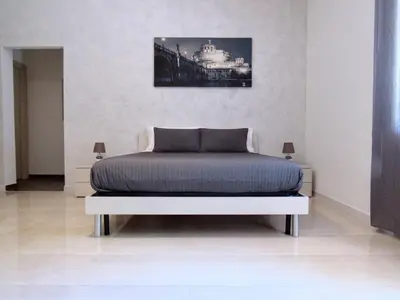 a bedroom with a bed and a bridge at Roema Guest House in Rome