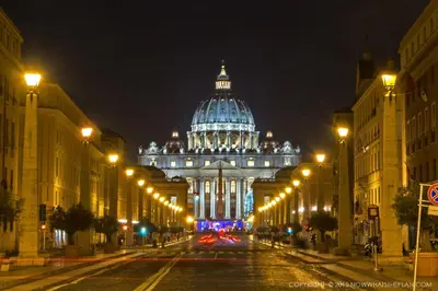 a view of a building with a dome at night at Penta Luxury House in Rome