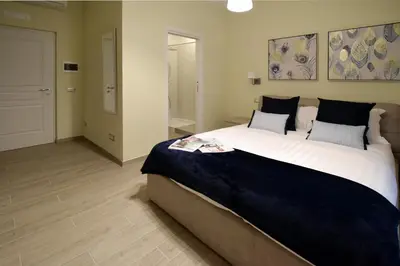a bedroom with a large bed and a bathroom at CdR Guest House in Rome
