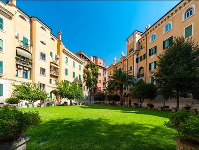 a green yard in a city with buildings at MoonLight Suite in Rome