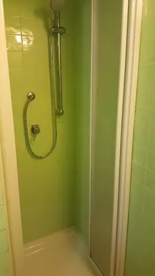 a bathroom with a shower with green tiles at MoonLight Suite in Rome