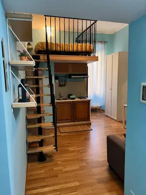 a living room with a loft bed and a kitchen at MoonLight Suite in Rome